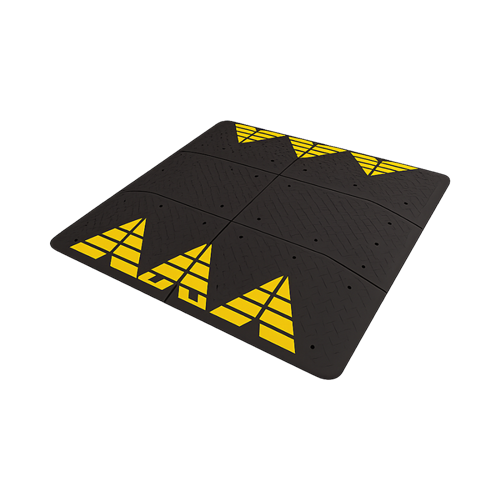 Cojín berlinés de caucho reciclado en módulos negro y amarillo para reducción de velocidad urbana.